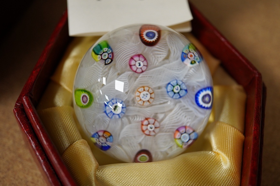 Two Perthshire glass Christmas paperweights for 1981 and 1983, a Perthshire miniature Latticino weight, 18/400, dated 1982, and a Selkirk glass Millefiori crown paperweight, 1982, (4) Largest Perthshire paperweight 8cm
